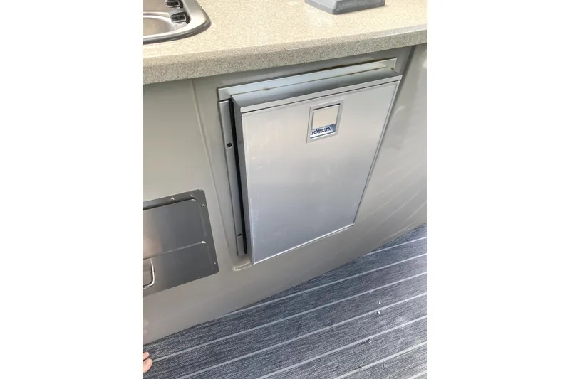 Slide: The Image of Luxurious 2022 Premier Escalante boat interior with leather captain's chair and steering wheel. - 22