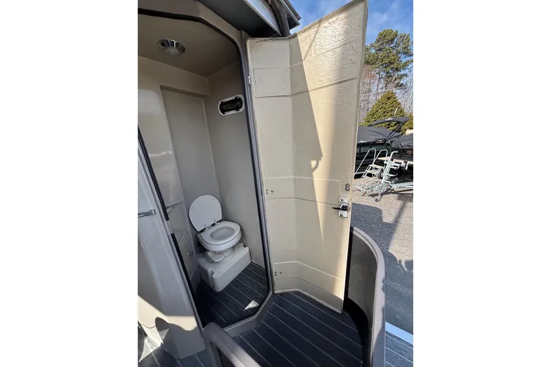 Slide: The Image of Interior of 2022 Premier Escalante boat bathroom with toilet and open door. - 36