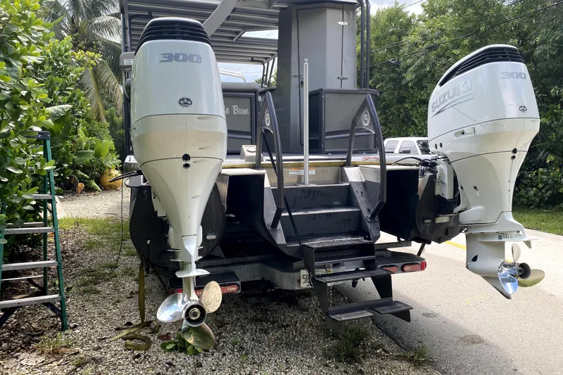 The Image of 2022 Premier Escalante pontoon boat with triple-axle trailer, parked outdoors. - 5