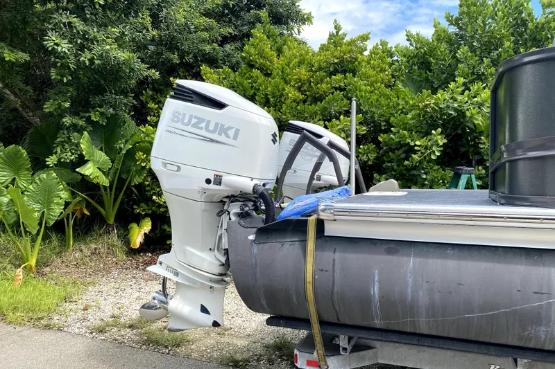 Slide: The Image of 2022 Premier Escalante boat motor with propeller on asphalt surface. - 8