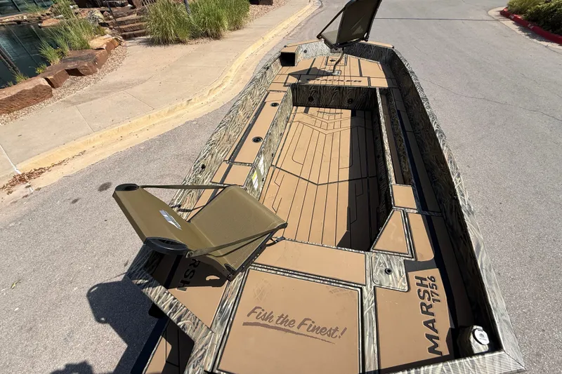 Slide: The Image of 2026 Tracker Grizzly 1756 T Marsh boat with camo design and open deck layout. - 8