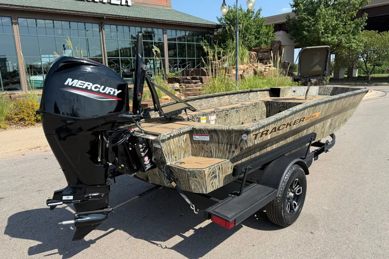 Slide: The Image of 2026 Tracker Grizzly 1756 T Marsh boat with Mercury engine, parked outdoors. - 6