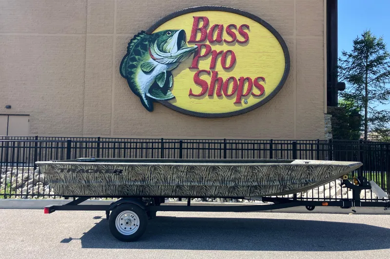 The Image of 2026 Tracker Grizzly 1648 Utility boat at Bass Pro Shops, displayed on a trailer. - 0