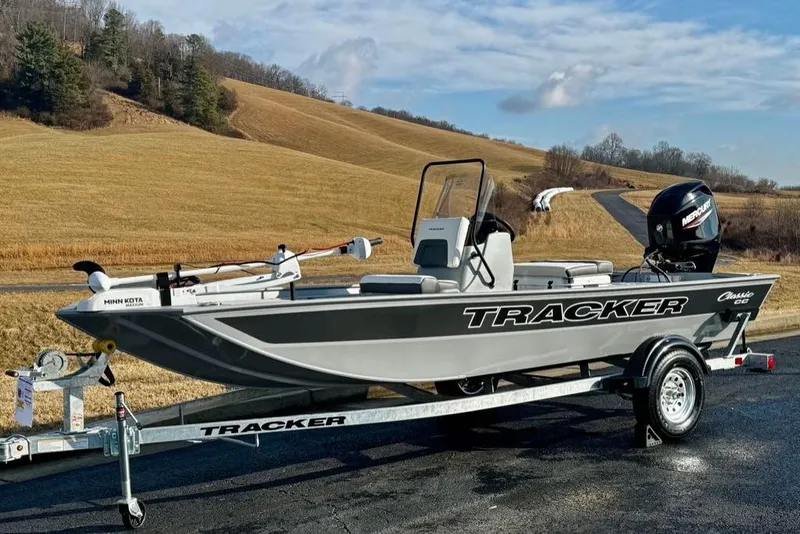The Image of 2026 Tracker Bass Tracker Classic CC boat on trailer in scenic countryside. - 0