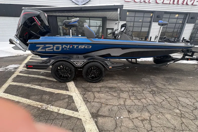 Slide: The Image of 2026 Nitro Z20 XL boat on trailer, parked outside a service center. - 80