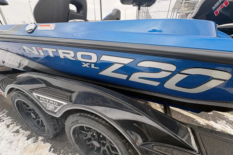 Slide: The Image of 2026 Nitro Z20 XL boat, blue exterior, parked on a snowy surface. - 81