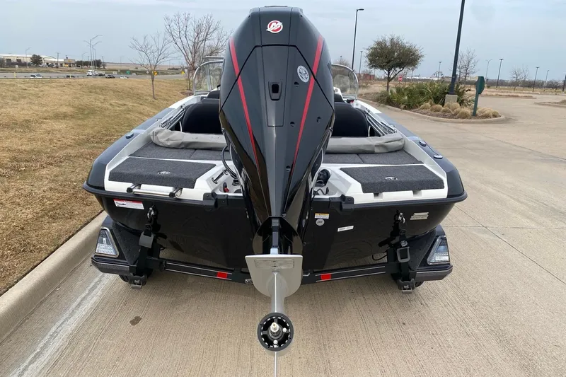 Slide: The Image of 2026 Ranger 212LS boat with powerful outboard motor, parked on a concrete surface. - 16