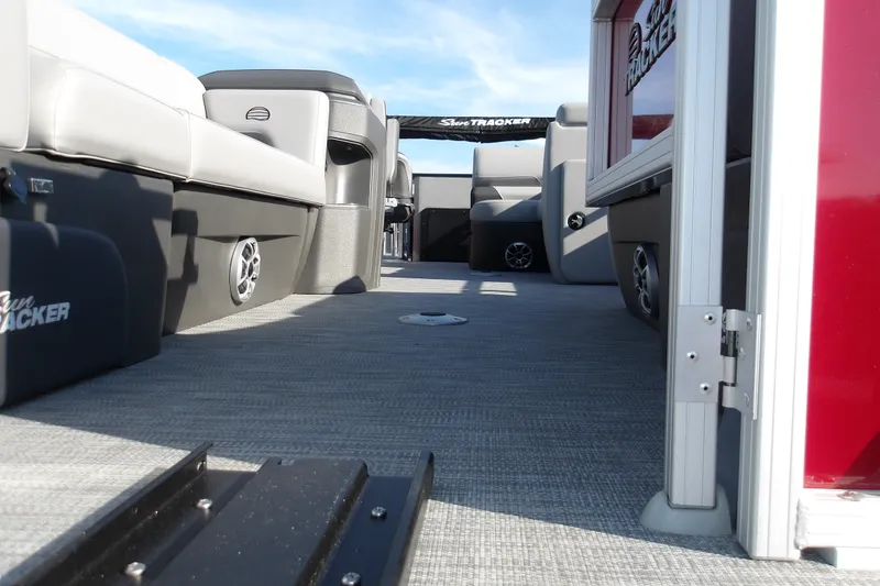 Slide: The Image of 2026 Sun Tracker SportFish 22 DLX pontoon boat interior with seating and speakers. - 25