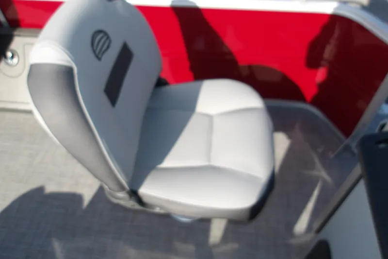 Slide: The Image of Boat seat on 2026 Sun Tracker SportFish 22 DLX, featuring gray upholstery and red paneling. - 14
