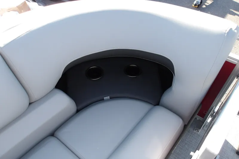 Slide: The Image of 2026 Sun Tracker SportFish 22 DLX boat seat with cup holders, featuring light gray upholstery. - 24