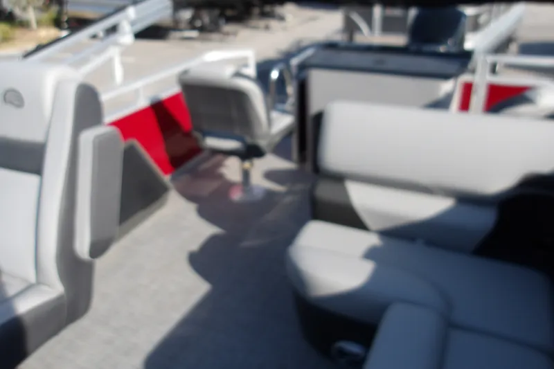 Slide: The Image of Blurry interior of 2026 Sun Tracker SportFish 22 DLX pontoon boat with seating. - 21