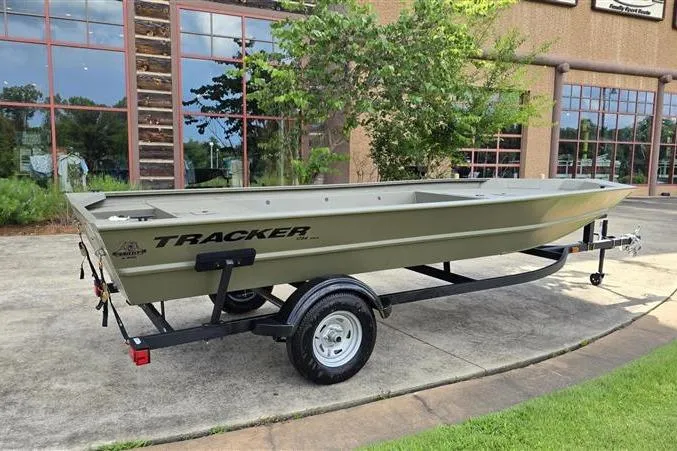 Slide: The Image of 2026 Tracker Grizzly 1754 Utility boat on trailer, parked outdoors near a building. - 6