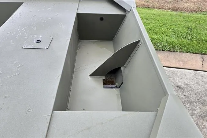 Slide: The Image of 2026 Tracker Grizzly 1754 Utility boat interior, showcasing storage compartment and durable design. - 8
