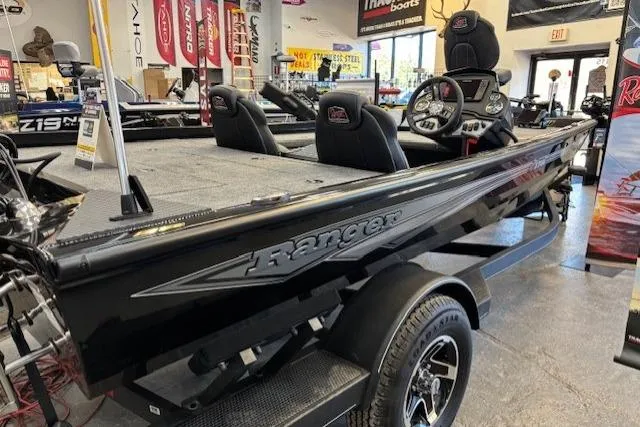 The Image of 2026 Ranger RT178C boat in showroom, sleek black design, modern interior features. - 0