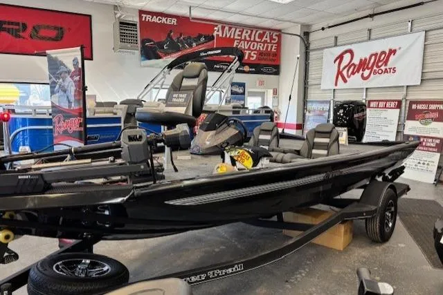 Slide: The Image of 2026 Ranger RT178C fishing boat displayed in showroom with promotional banners. - 2