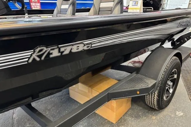 Slide: The Image of 2026 Ranger RT178C boat, black exterior, displayed indoors on a trailer. - 4