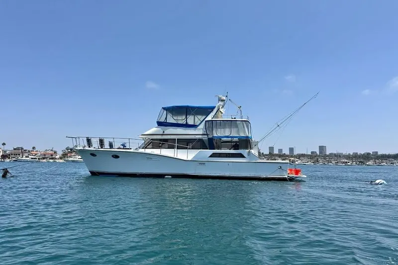 The Image of 1987 Symbol 51 Classic yacht anchored in calm waters under a clear blue sky. - 0