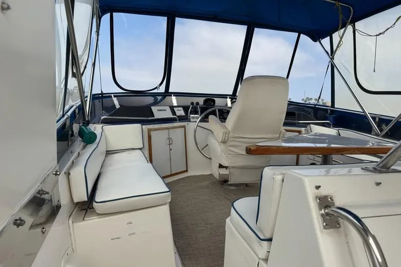 Slide: The Image of Interior of a 1987 Symbol 51 Classic boat with white seating and blue accents. - 2