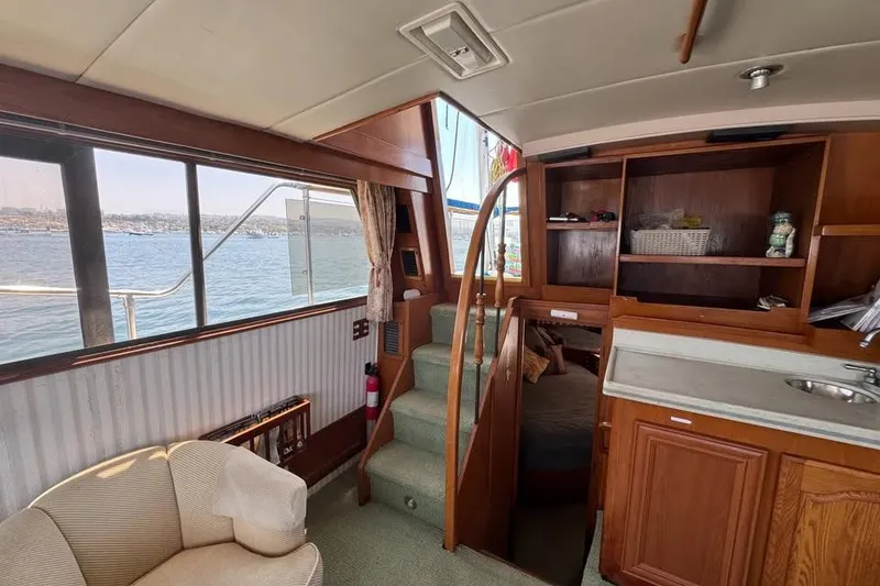 Slide: The Image of Interior of 1987 Symbol 51 Classic yacht with wooden cabinetry and waterfront view. - 5