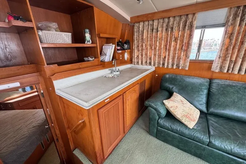 Slide: The Image of Interior of a 1987 Symbol 51 Classic yacht with kitchenette and green sofa. - 7