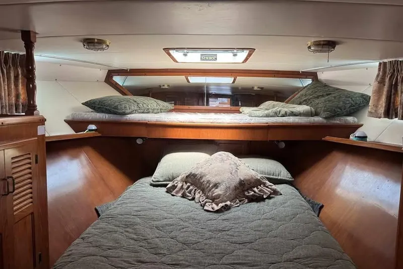Slide: The Image of Cozy cabin interior of 1987 Symbol 51 Classic yacht with wooden finish and bedding. - 8