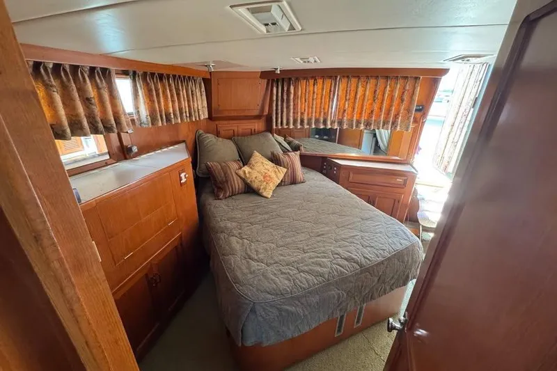 Slide: The Image of Cozy bedroom in 1987 Symbol 51 Classic yacht with wood paneling and patterned curtains. - 9