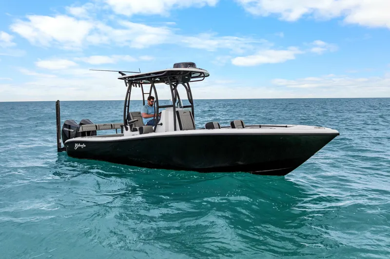 The Image of 2025 Yellowfin 26 Hybrid boat on open sea under blue sky. - 0