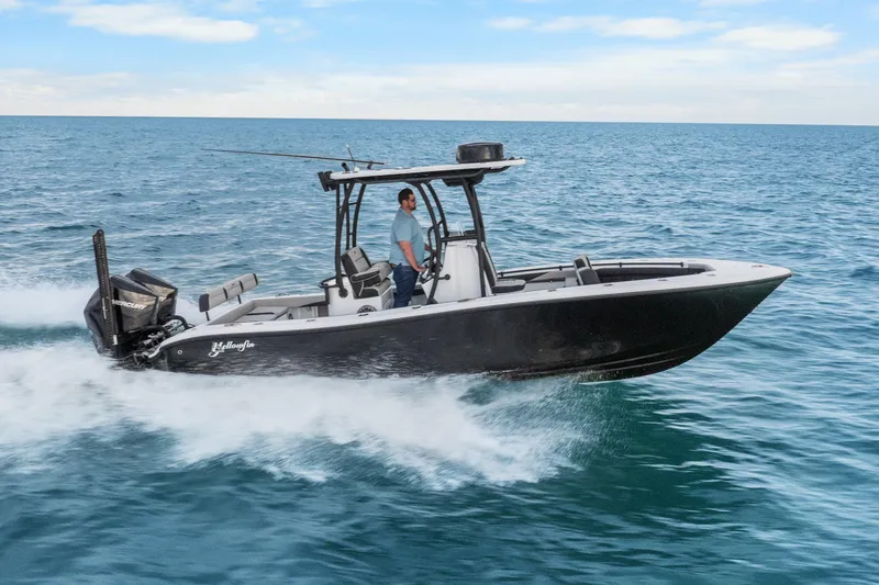 Slide: The Image of 2025 Yellowfin 26 Hybrid boat cruising on open water. - 13