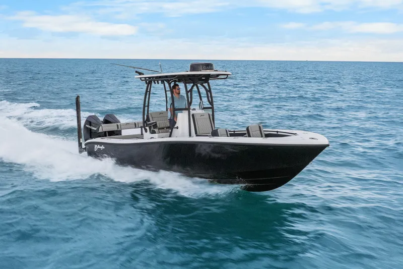 Slide: The Image of 2025 Yellowfin 26 Hybrid boat cruising on open ocean waters. - 14