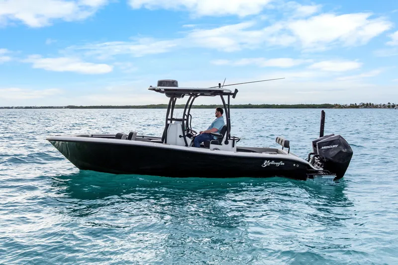 Slide: The Image of 2025 Yellowfin 26 Hybrid boat on open water under a clear blue sky. - 2