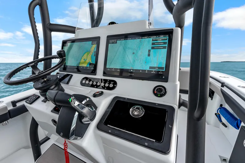 Slide: The Image of 2025 Yellowfin 26 Hybrid boat dashboard with dual navigation screens and steering wheel. - 21