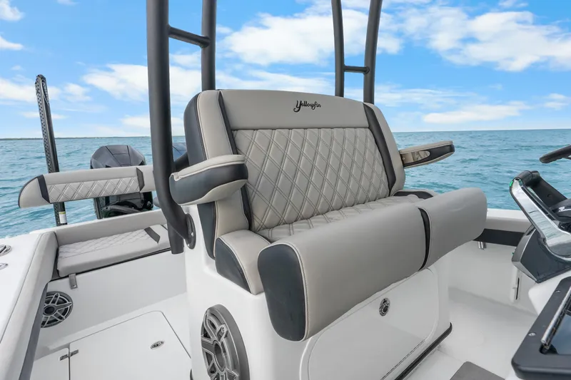 Slide: The Image of 2025 Yellowfin 26 Hybrid boat interior with luxurious seating and ocean backdrop. - 23
