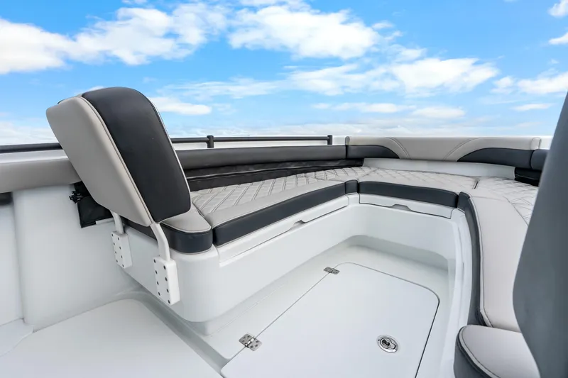 Slide: The Image of 2025 Yellowfin 26 Hybrid boat interior with cushioned seating under a blue sky. - 26