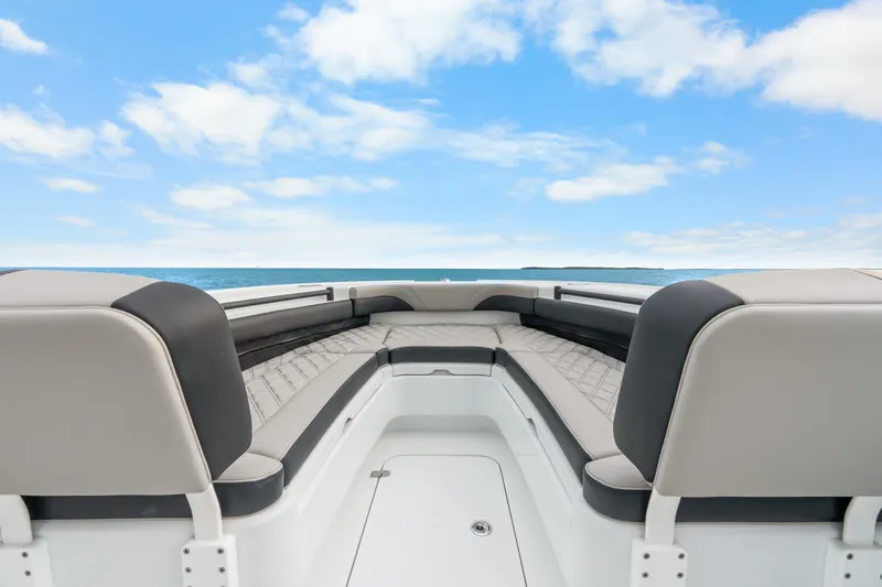Slide: The Image of 2025 Yellowfin 26 Hybrid boat interior with cushioned seating, ocean view, and blue sky. - 27