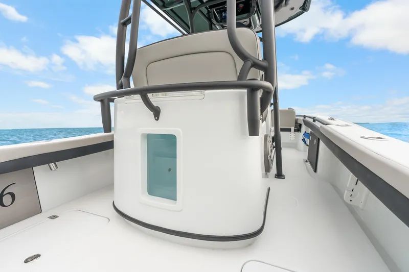 Slide: The Image of 2025 Yellowfin 26 Hybrid boat interior with seating, ocean view, and clear sky. - 30