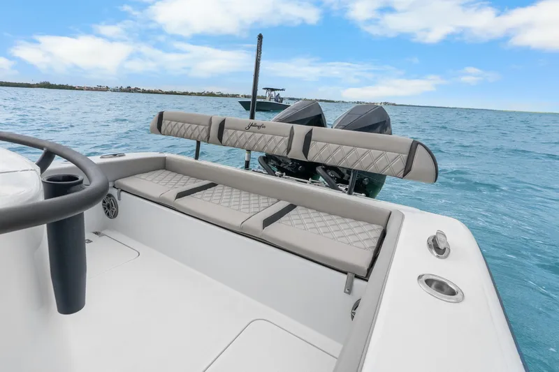 Slide: The Image of 2025 Yellowfin 26 Hybrid boat on open water, featuring sleek seating and dual engines. - 32