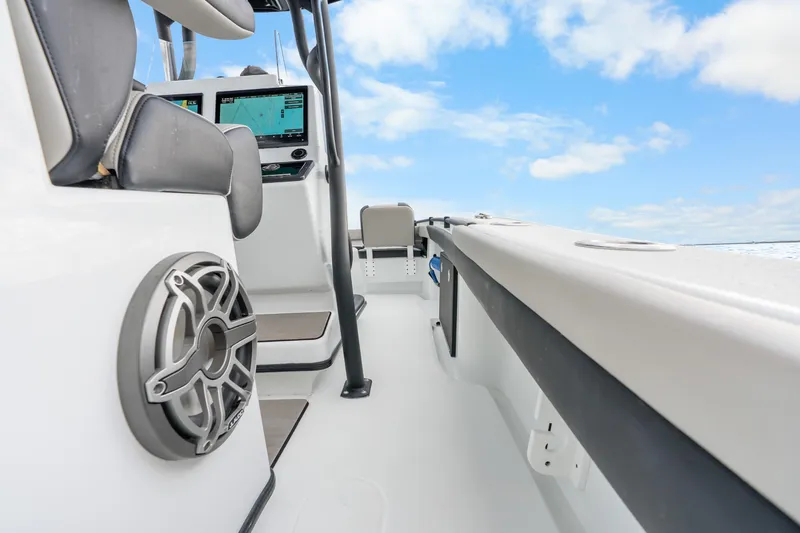 Slide: The Image of 2025 Yellowfin 26 Hybrid boat interior with modern controls and speaker, under blue sky. - 35