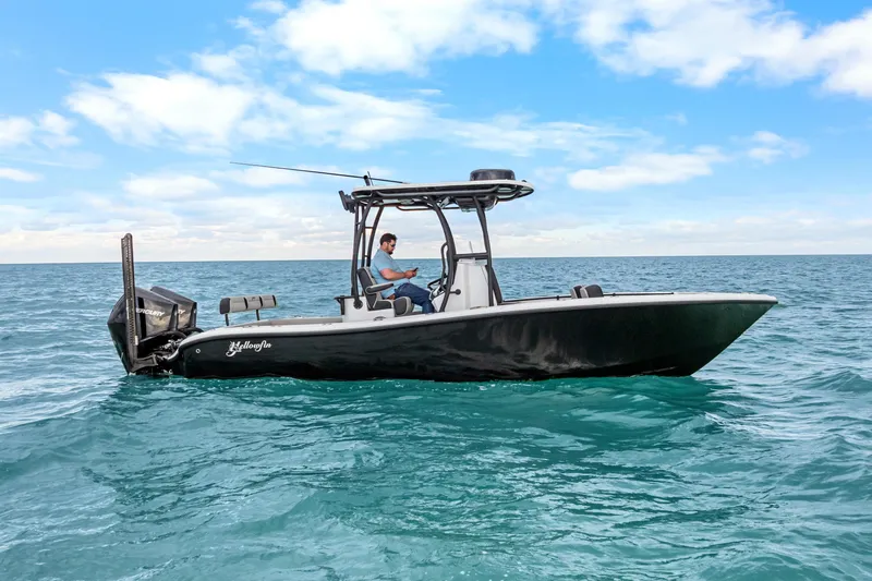 Slide: The Image of 2025 Yellowfin 26 Hybrid boat cruising on open ocean under blue sky. - 8