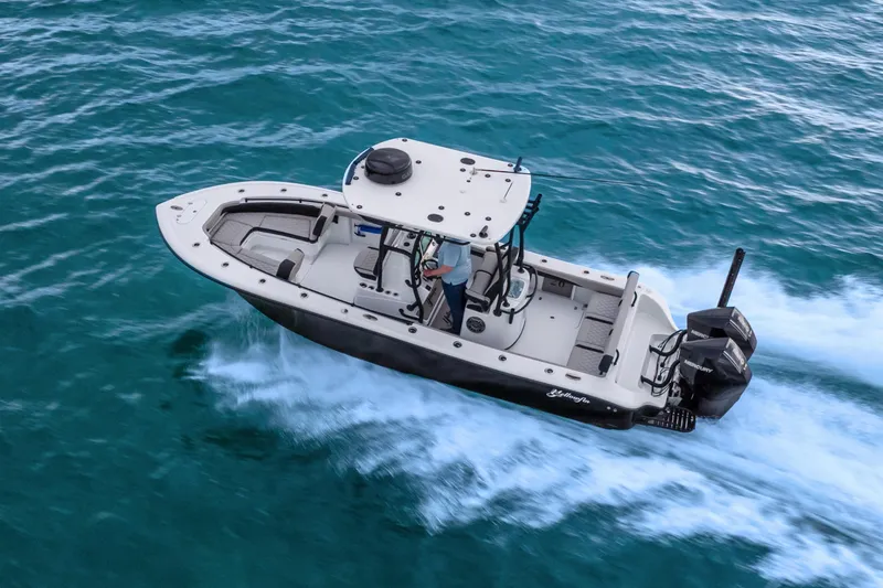 Slide: The Image of 2025 Yellowfin 26 Hybrid boat cruising on open water. - 9