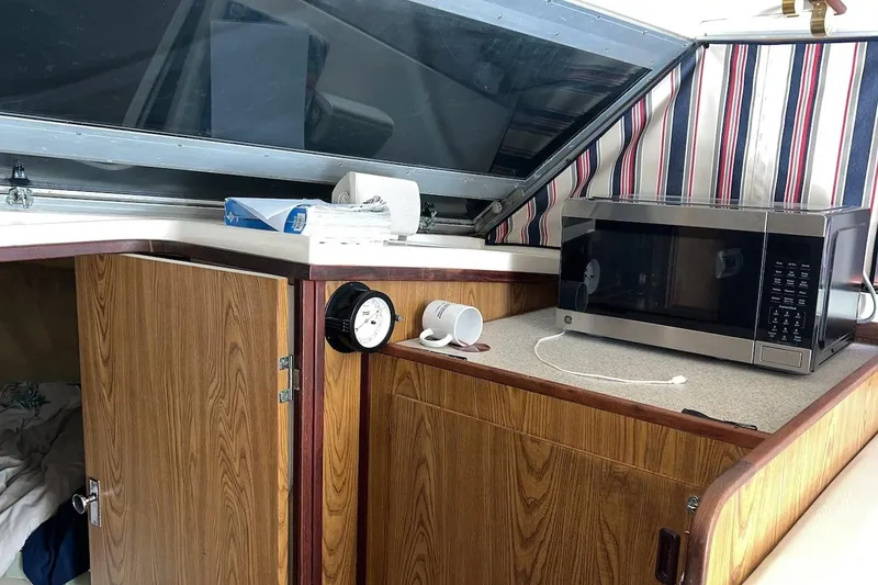 Slide: The Image of Interior of 1981 Bertram 33 Sport Fisherman with kitchenette and cozy sleeping area. - 12