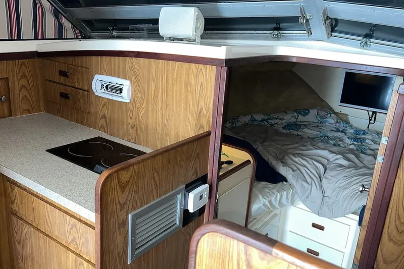 Slide: The Image of Interior of 1981 Bertram 33 Sport Fisherman with microwave and wooden cabinets. - 13