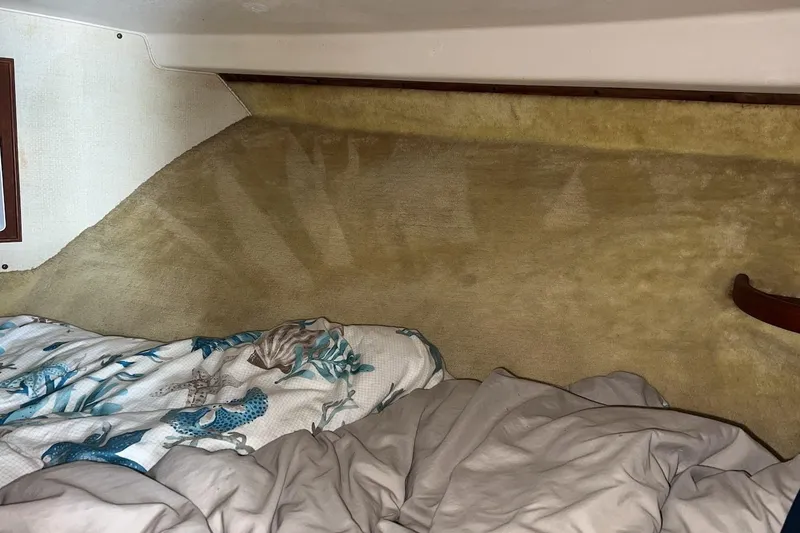 Slide: The Image of 1981 Bertram 33 Sport Fisherman interior with kitchenette and cozy sleeping area. - 14