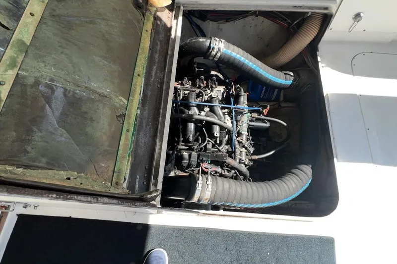 Slide: The Image of Interior of 1981 Bertram 33 Sport Fisherman with wood paneling and striped curtains. - 16