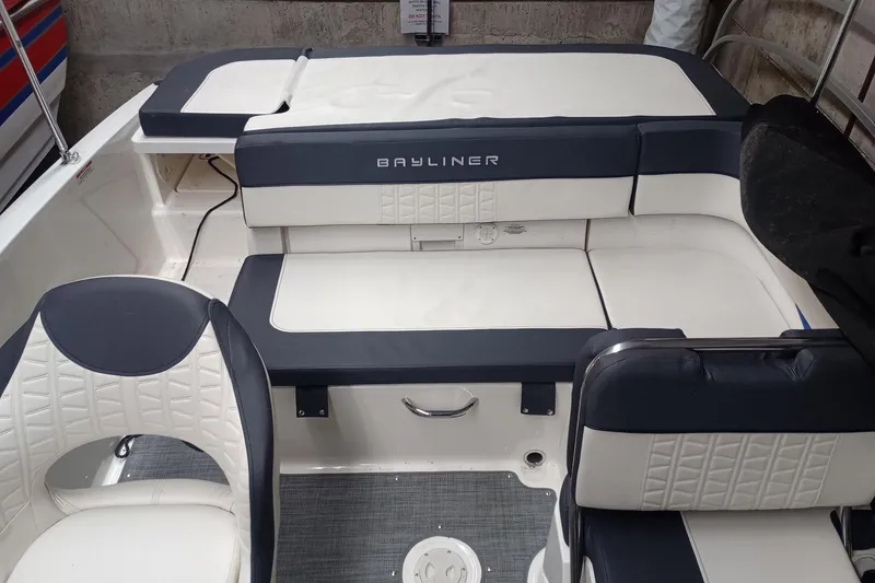 Slide: The Image of 2022 Bayliner VR5 Bowrider I/O interior with white and navy seating, showcasing modern design. - 12