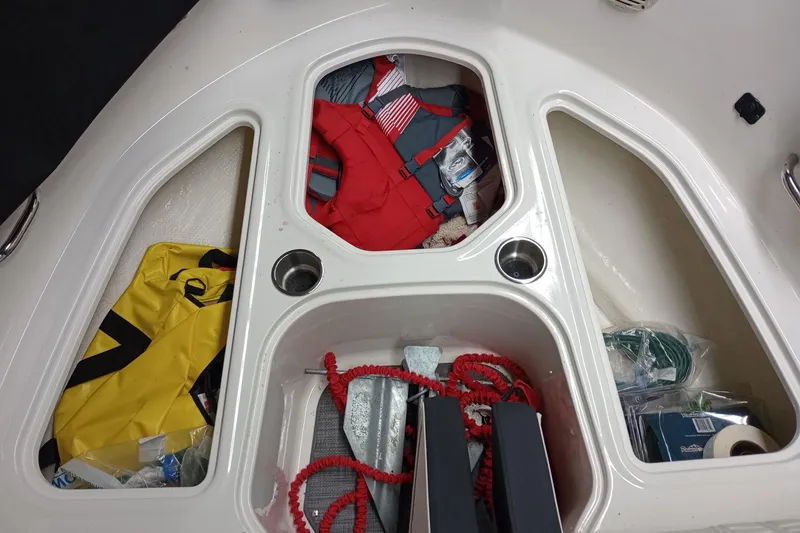 Slide: The Image of 2022 Bayliner VR5 Bowrider I/O storage compartments with life jackets and boating gear. - 15