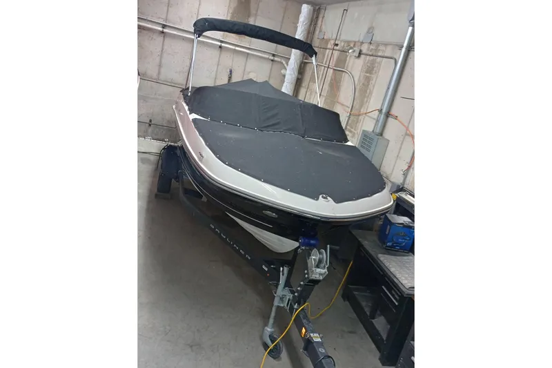 Slide: The Image of 2022 Bayliner VR5 Bowrider I/O boat in storage, covered and on a trailer. - 18