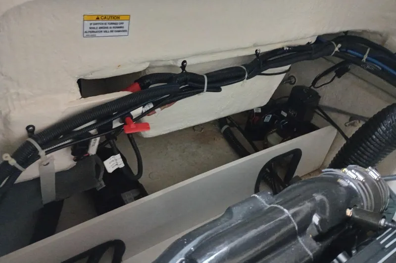 Slide: The Image of 2022 Bayliner VR5 Bowrider I/O engine compartment with wiring and components. - 21