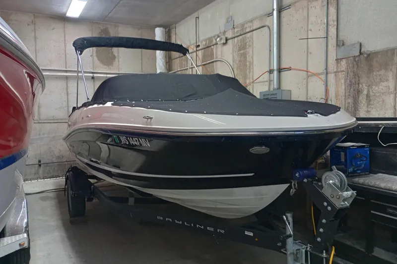 Slide: The Image of 2022 Bayliner VR5 Bowrider I/O boat in storage, covered and on a trailer. - 22