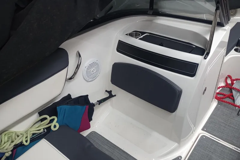 Slide: The Image of 2022 Bayliner VR5 Bowrider I/O interior with seating, ropes, and storage compartments. - 26