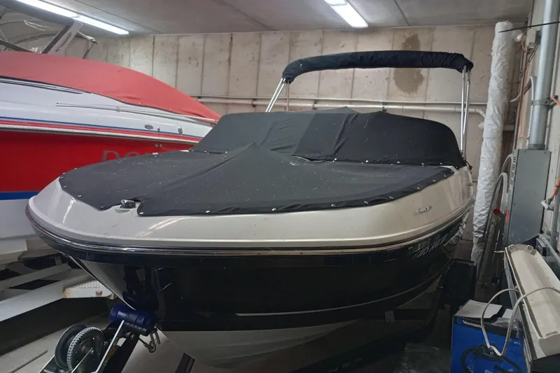 Slide: The Image of 2022 Bayliner VR5 Bowrider I/O boat with cover in indoor storage. - 27